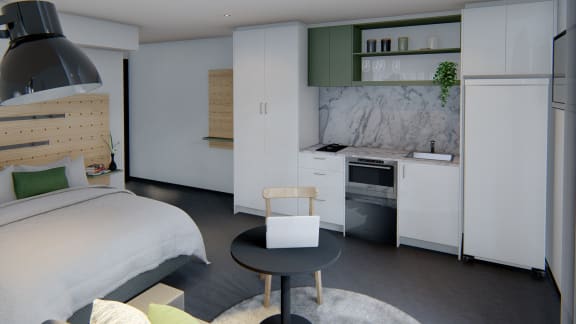 a small bedroom with a bed and a kitchen