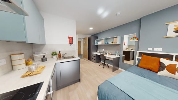 a bedroom with a bed and a desk in a small room