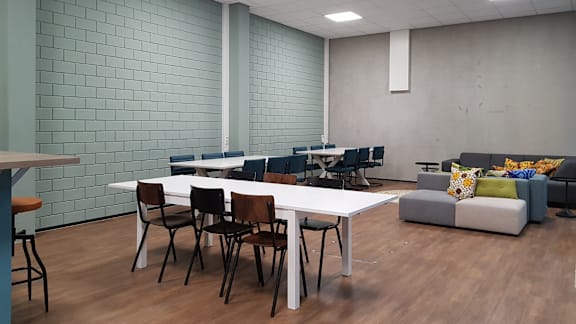 A room with a long table and chairs.