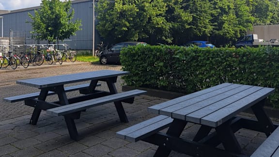 A picnic table is in the foreground of a park.
