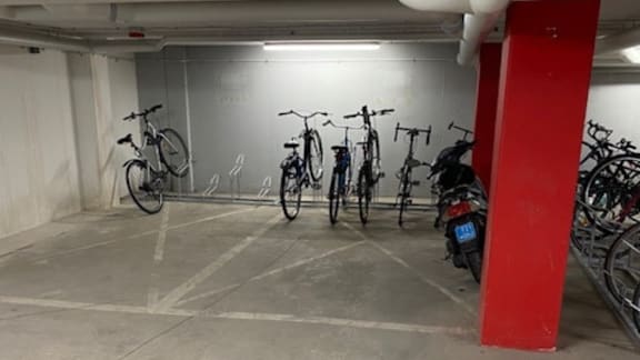A bike parking area with bikes parked in a row.