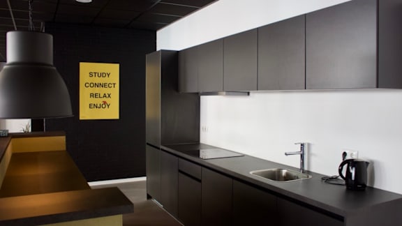 A modern kitchen with a sign that says "Study Connect Relax Enjoy".
