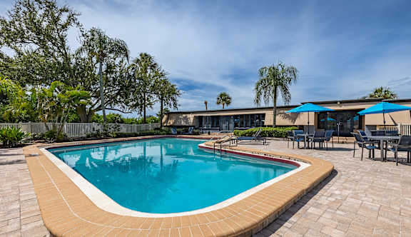 A large outdoor swimming pool surrounded by a patio and trees at Waterview at Rocky Point, Florida, 33634