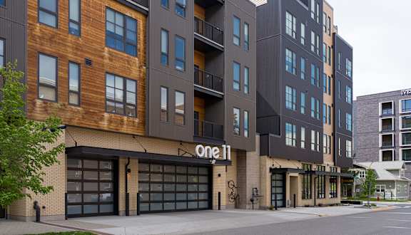 A modern building with the name One 11 on the front.