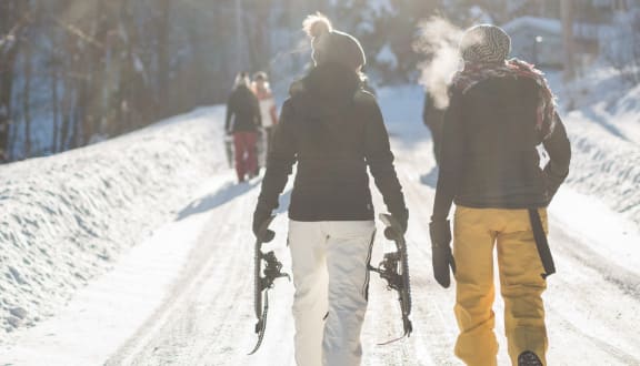 Friends Walking in Snow Together