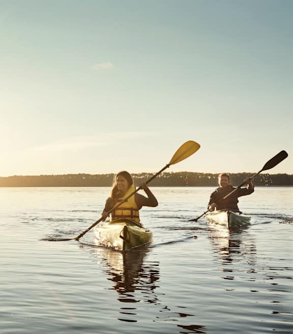 Two People Kayaking During Sunset