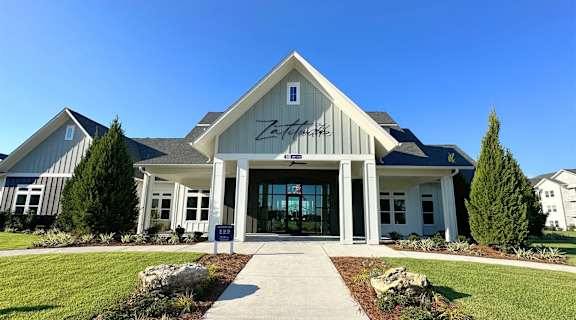 the exterior of the zephyrhills event center with a blue sky background