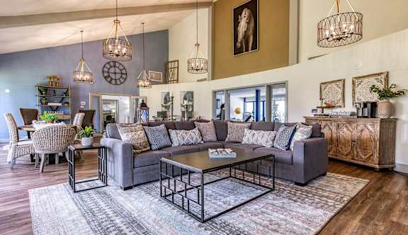 A living room with a grey sofa and a coffee table in the center.