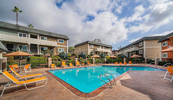 our apartments have a swimming pool with chairs and umbrellas