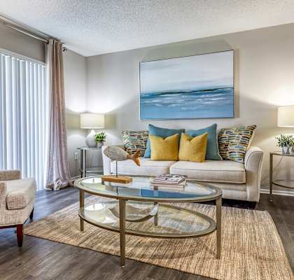 a living room with a couch and chairs and a coffee table at L'Estancia, Sarasota, FL