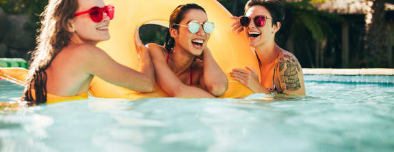 three women swimming in a pool at Hidden Creek, Morrow, GA 30260