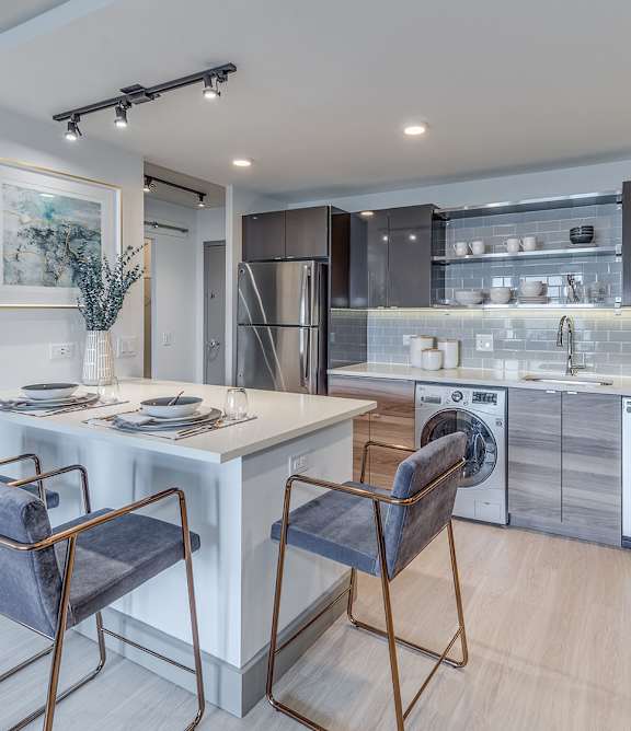A modern kitchen with stainless steel appliances and wooden cabinets.