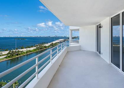 A balcony with a view of a body of water and a city skyline. at The Hamilton, Miami, FL