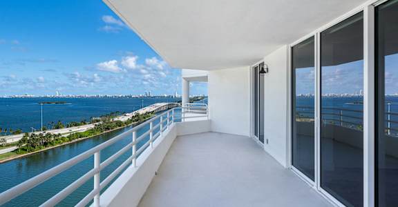 A balcony with a view of a body of water and a city skyline. at The Hamilton, Miami, FL