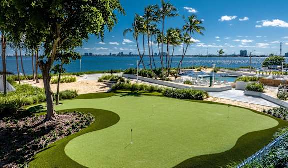 A golf course with a green and a flag on it. at The Hamilton, Miami, 33137