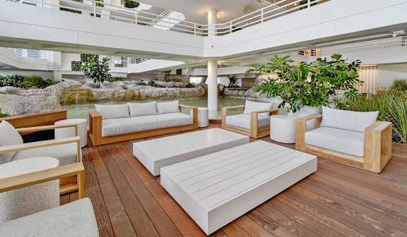 A white couch is in the middle of a wooden deck. at The Hamilton, Miami, 33137