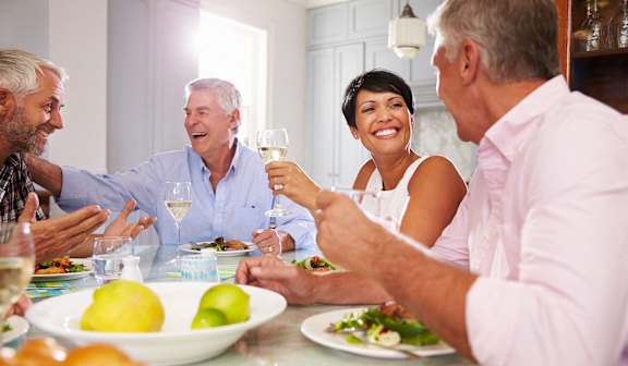 a group of people sitting around a table eating food and drinking wine  at The Hamilton, Miami, Florida