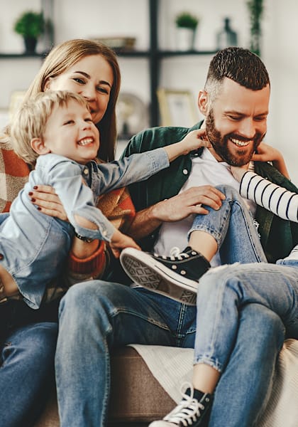 a family sitting on a couch with two children at Summit Ridge Apartments, Temple, TX
