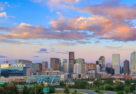 a view of the denver skyline at sunset