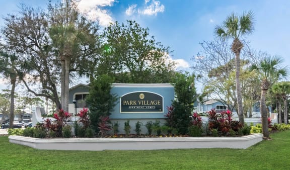 the sign for park village at the entrance of the park villa apartments