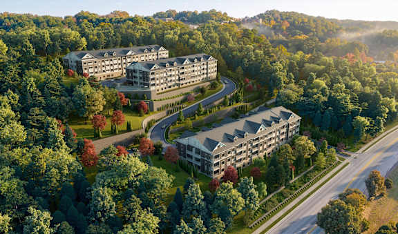 A large building complex is surrounded by trees in the image.
