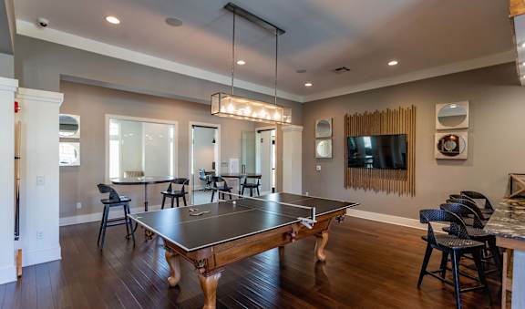 A modern dining room with a wooden table and chairs.