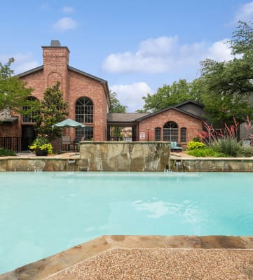 Community Swimming Pool and Waterfall at Dallas North Park Apartments in Dallas, TX-HERO.