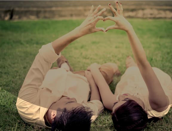 Young Couple Making Heart with Hands