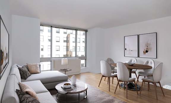 A modern living room with a grey sofa and a round coffee table.at 'The Metropolis', New York, 10017