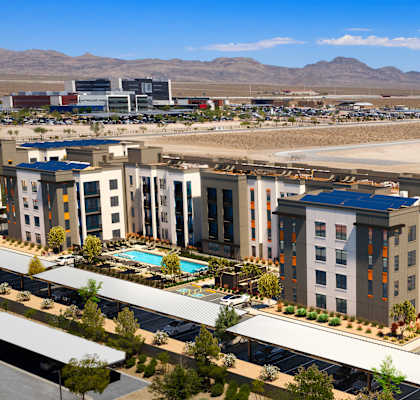 A large building complex with a pool in the middle.