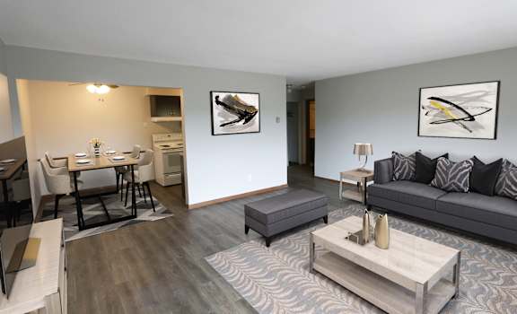 A modern living room with a grey couch and a coffee table.