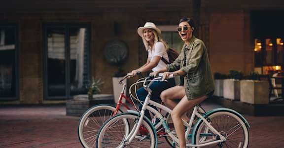 two women riding bikes on the street at The Ridge at Chenal Valley, Little Rock, Arkansas