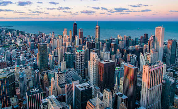 A cityscape with numerous buildings of varying heights and designs.