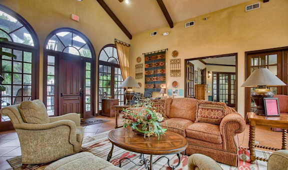 a living room with a couch and chairs and a table