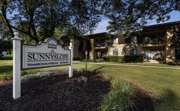 a sign that says sunnyside in front of a house