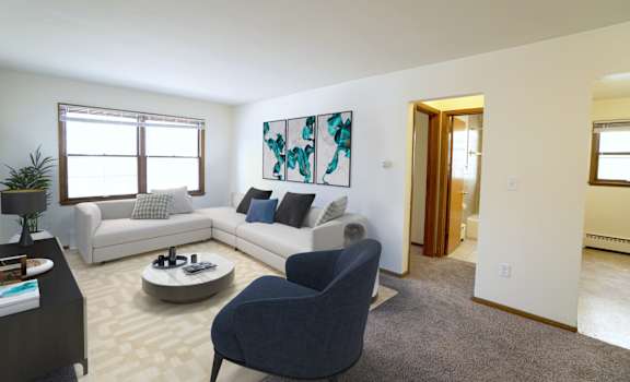 a living room with a white couch and a blue chair
