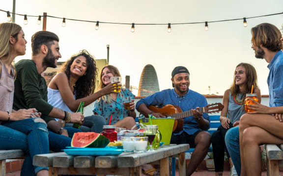 a group of people standing around a grill eating food at 808 Berry Place, Minnesota