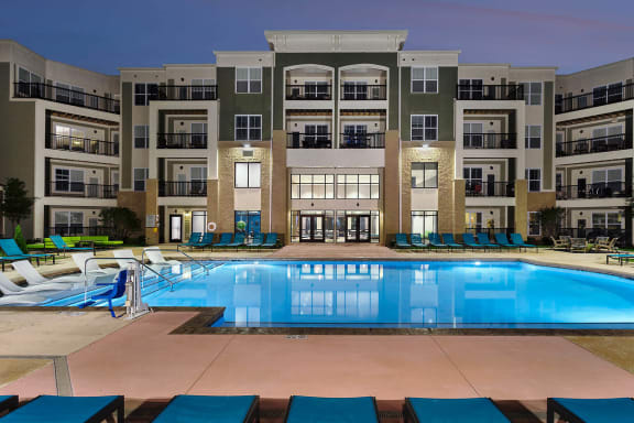 Stunning Apartment Community at Dusk with a Goergous Blue Swimming Pool at Mosaic at Levis Commons in Perrysburg, OH, 43551