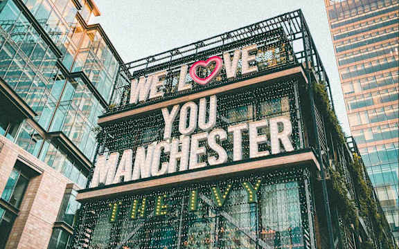 A sign that says "We love you Manchester" is displayed.