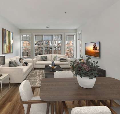 a living and dining area with a wooden table and white couches