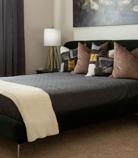 a bedroom with a bed and pillows at Esplanade District Apartments, Little Rock
