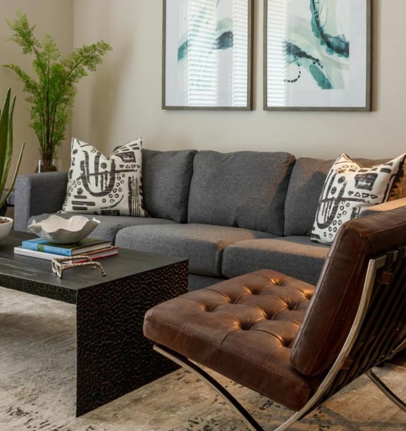 a living room with a couch and a coffee table at Esplanade District Apartments, Little Rock