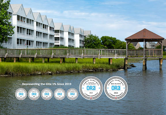 A building with a body of water in front of it and a gazebo.