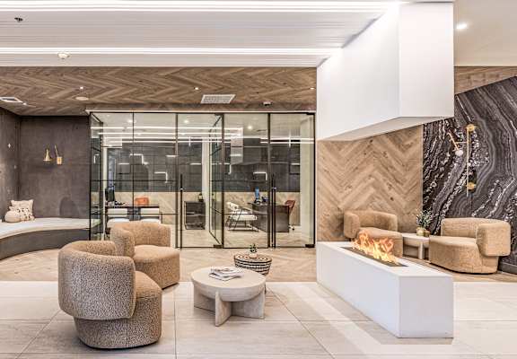 a rendering of a lobby with chairs and a fireplace