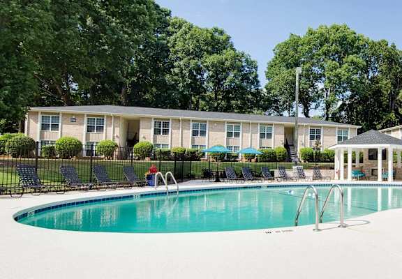 a swimming pool with a building in the background