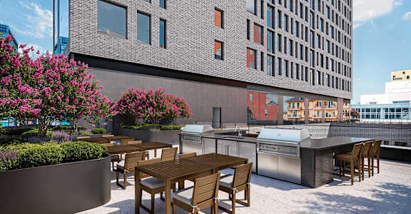 A patio with a table and chairs is in front of a building.