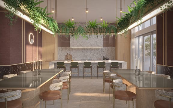 A modern kitchen with a long counter and bar stools.