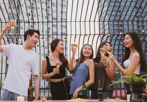 A group of people are enjoying drinks together at a table.