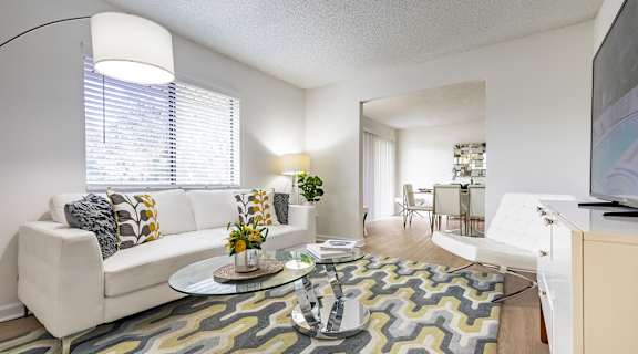 A living room with a white couch and a glass coffee table at Waterview at Rocky Point, Florida, 33634