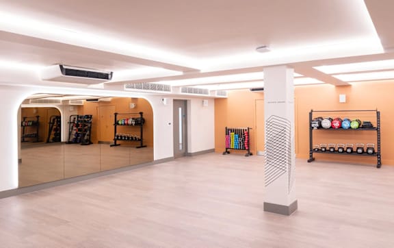A room with a large mirror and a shelf with various items on it.